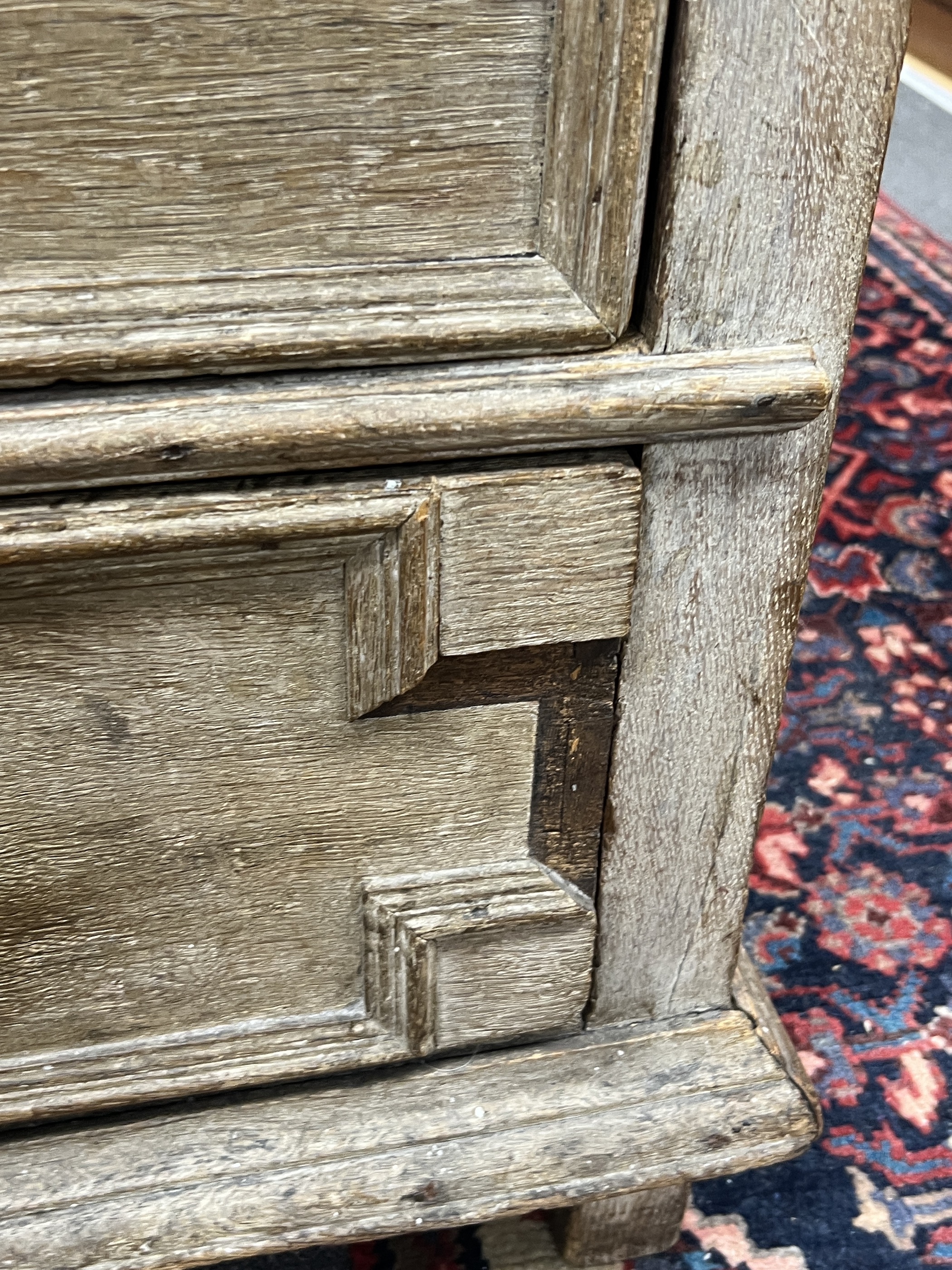 An 18th century geometric moulded oak chest of drawers, width 98cm, depth 57cm, height 92cm